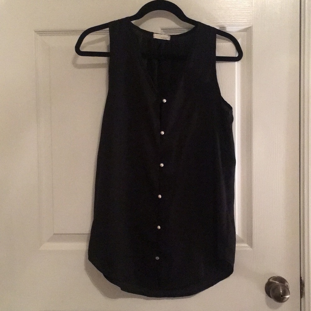 Black sheer blouse and it’s pearl buttons.